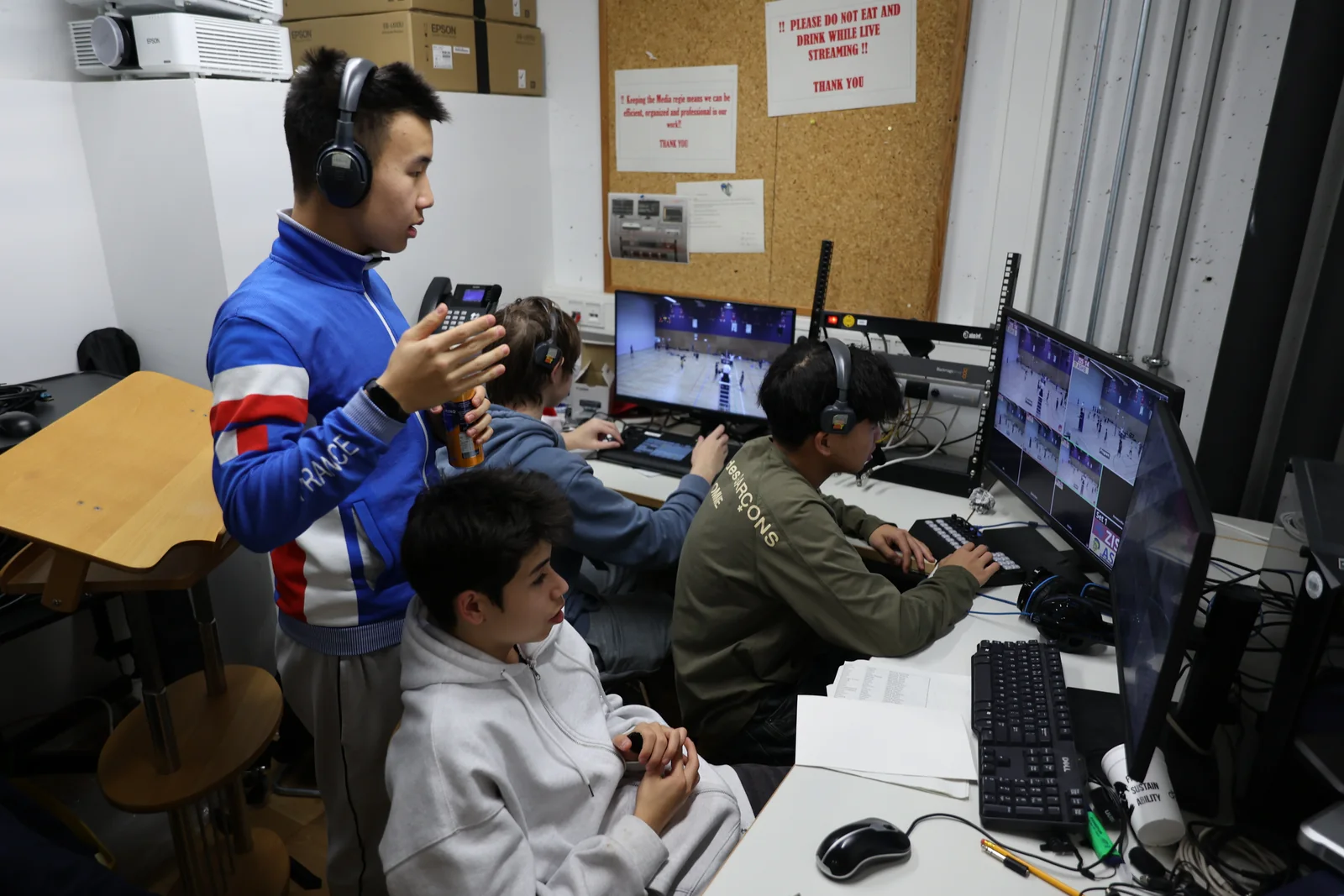 Students directing and monitoring a sports livestream from the control room